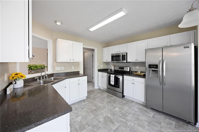 5511 Shady Lawn Dr, Hope Mills, NC 28348 - kitchen with appliances with stainless steel finishes, a sink, and dark countertops