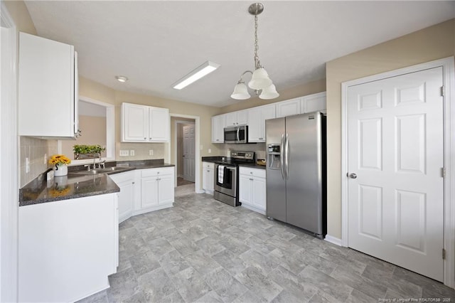 5511 Shady Lawn Dr, Hope Mills, NC 28348 - kitchen with appliances with stainless steel finishes, dark countertops, a sink, a chandelier, and white cabinets