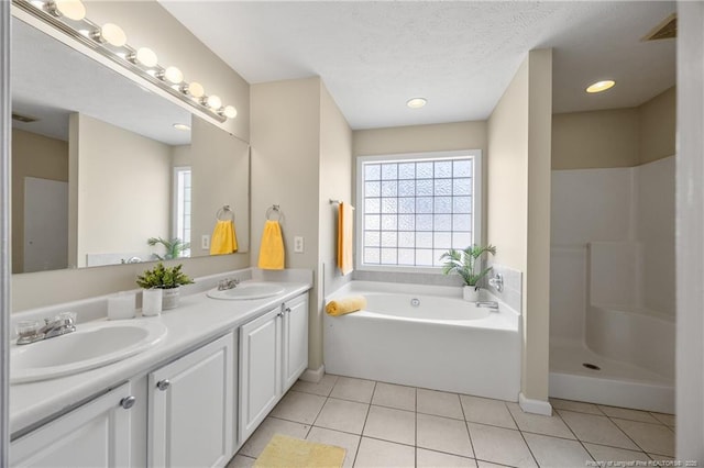 5511 Shady Lawn Dr, Hope Mills, NC 28348 - bathroom with double vanity, a garden tub, healthy amount of natural light, and tile patterned flooring