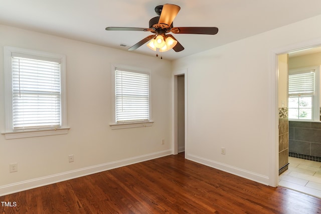 325 Northfield Dr, Raleigh, NC 27609 - unfurnished room with wood finished floors, a ceiling fan, and baseboards