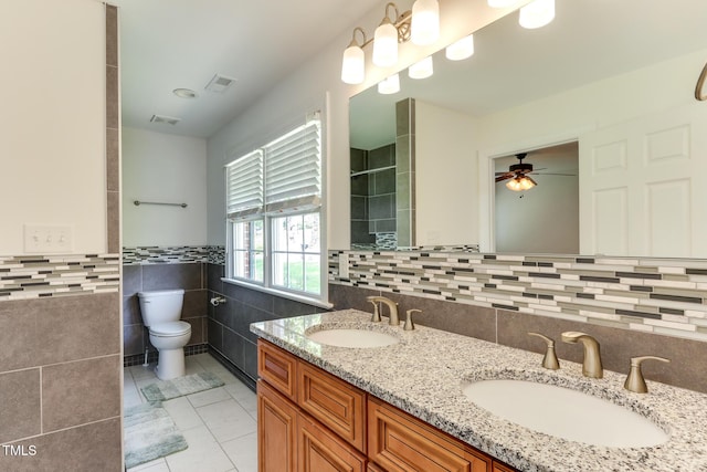 325 Northfield Dr, Raleigh, NC 27609 - bathroom featuring tile walls, tile patterned flooring, double vanity, tiled shower, and a ceiling fan