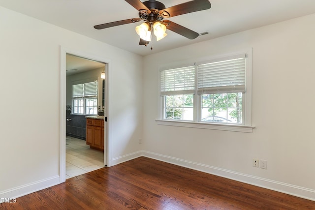 325 Northfield Dr, Raleigh, NC 27609 - spare room featuring wood finished floors, baseboards, and a ceiling fan