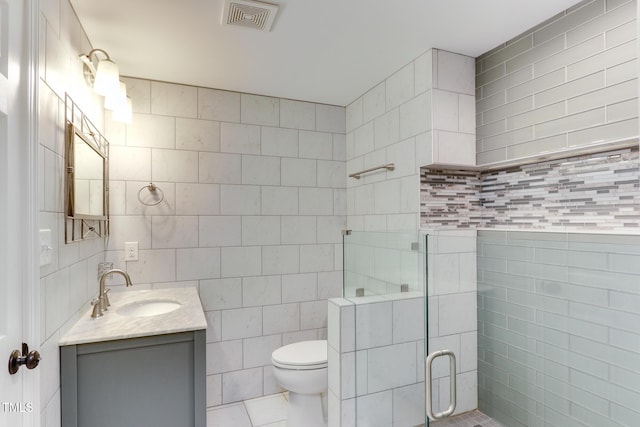 325 Northfield Dr, Raleigh, NC 27609 - full bath featuring tile walls, vanity, a shower stall, toilet, and tile patterned flooring