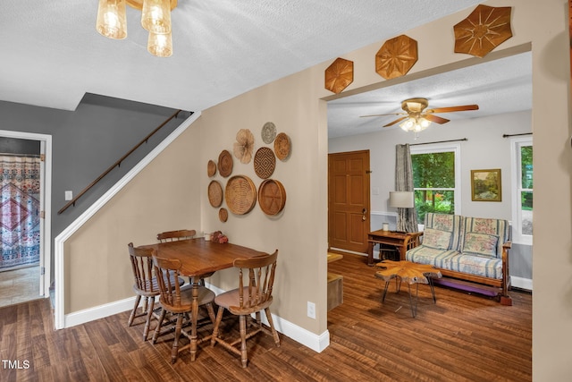 1869 Brevard Rd, Graham, NC 27253 - dining room featuring wood finished floors, stairs, a textured ceiling, ceiling fan, and baseboards
