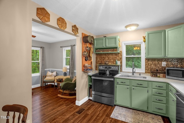 1869 Brevard Rd, Graham, NC 27253 - kitchen featuring appliances with stainless steel finishes, a sink, dark wood-type flooring, backsplash, and light countertops