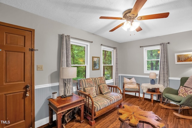 1869 Brevard Rd, Graham, NC 27253 - living area with wainscoting, plenty of natural light, wood finished floors, ceiling fan, and a textured ceiling