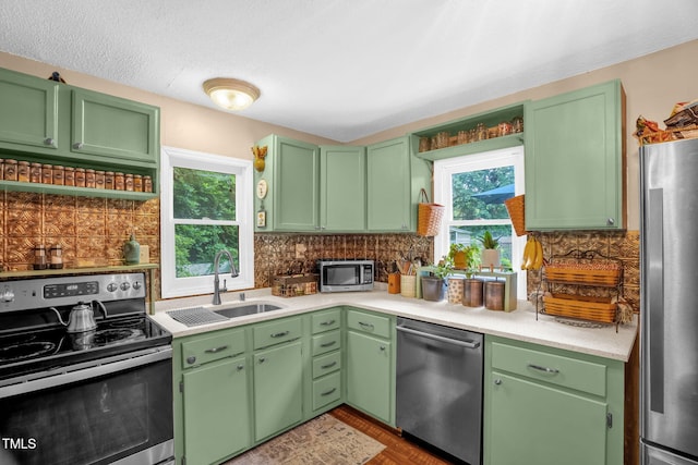 1869 Brevard Rd, Graham, NC 27253 - kitchen with stainless steel appliances, a sink, light countertops, and backsplash