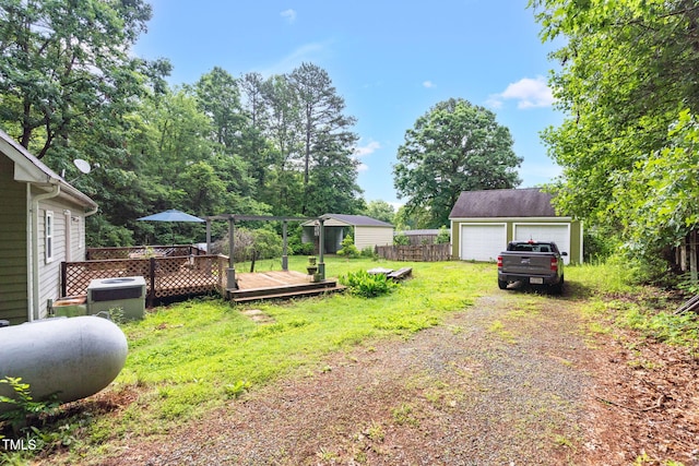 1869 Brevard Rd, Graham, NC 27253 - view of yard with a wooden deck, an outbuilding, a detached garage, central air condition unit, and dirt driveway
