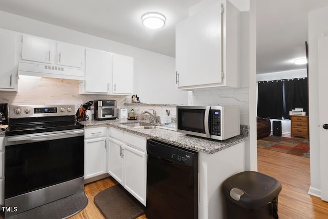 1824 Vintage Rd, Raleigh, NC 27610 - kitchen featuring appliances with stainless steel finishes, a sink, under cabinet range hood, decorative backsplash, and light wood-style flooring