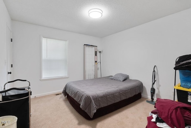 1824 Vintage Rd, Raleigh, NC 27610 - carpeted bedroom featuring a textured ceiling and baseboards