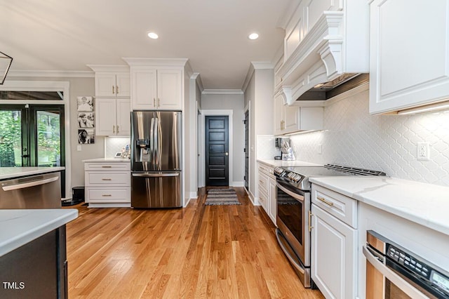 104 Crosby Ln, Sanford, NC 27330 - kitchen with stainless steel appliances, custom exhaust hood, crown molding, white cabinets, and backsplash