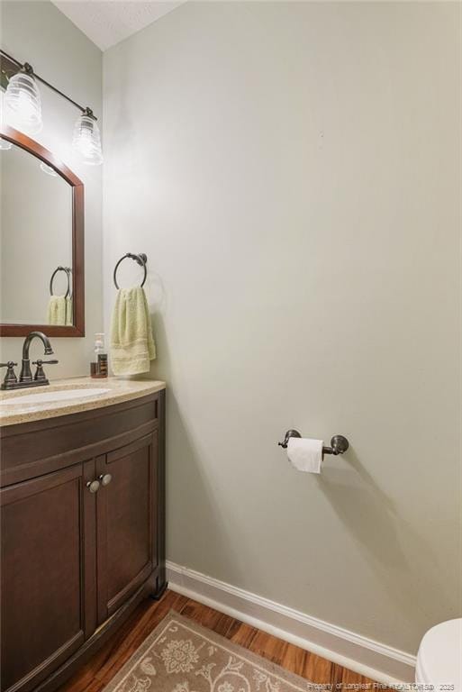 1314 Four Wood Dr, Fayetteville, NC 28312 - bathroom featuring wood finished floors, vanity, toilet, and baseboards