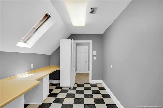 905 Mclean St, Raeford, NC 28376 - unfurnished office featuring tile patterned floors, lofted ceiling, a skylight, and baseboards