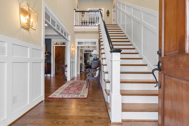 4737 Uzzle Rd, Rougemont, NC 27572 - entrance foyer with stairway, a decorative wall, and dark wood finished floors