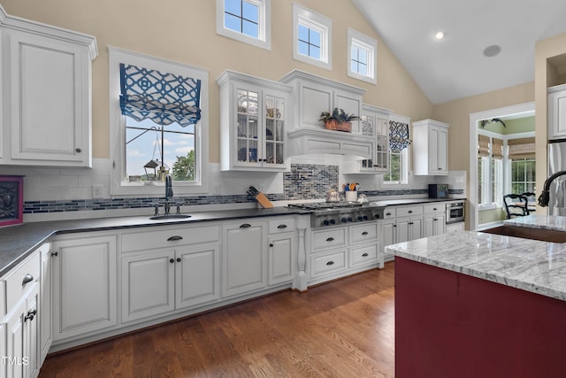 4737 Uzzle Rd, Rougemont, NC 27572 - kitchen featuring stainless steel gas stovetop, a sink, high vaulted ceiling, tasteful backsplash, and white cabinets