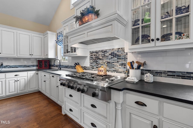 4737 Uzzle Rd, Rougemont, NC 27572 - kitchen with stainless steel gas cooktop, dark countertops, white cabinetry, a sink, and premium range hood