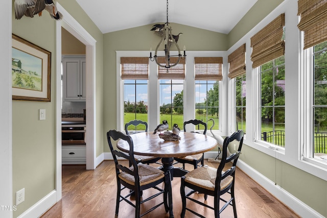 4737 Uzzle Rd, Rougemont, NC 27572 - sunroom / solarium with vaulted ceiling, plenty of natural light, wood finished floors, a chandelier, and baseboards