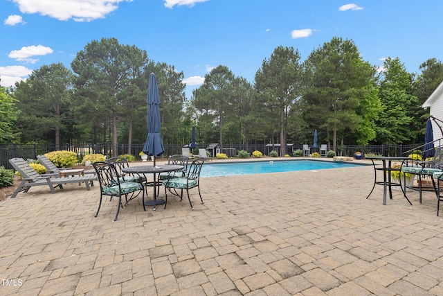 4737 Uzzle Rd, Rougemont, NC 27572 - community pool featuring a patio area, view of scattered trees, and outdoor dining area