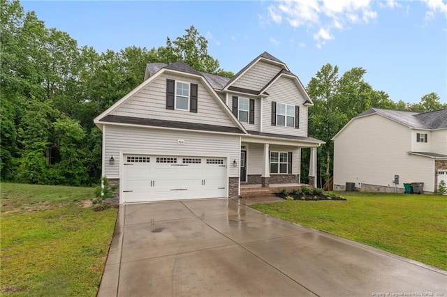 4616 Scenic Pines Dr, Hope Mills, NC 28348 - craftsman-style home featuring concrete driveway, a garage, a front lawn, covered porch, and stone siding