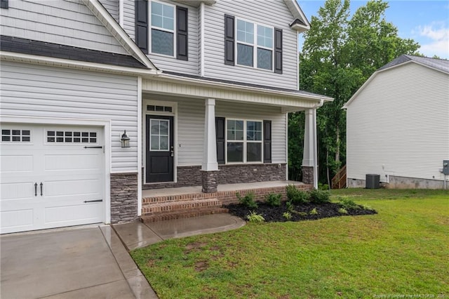 4616 Scenic Pines Dr, Hope Mills, NC 28348 - view of front of home featuring a porch, a front yard, stone siding, central air condition unit, and concrete driveway