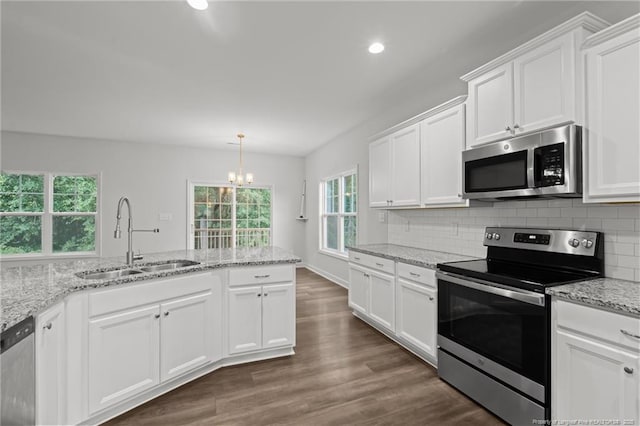 4616 Scenic Pines Dr, Hope Mills, NC 28348 - kitchen featuring stainless steel appliances, a sink, recessed lighting, a chandelier, and white cabinetry