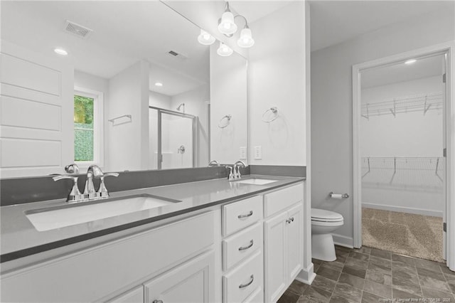 4616 Scenic Pines Dr, Hope Mills, NC 28348 - full bath featuring toilet, a shower stall, double vanity, a walk in closet, and baseboards