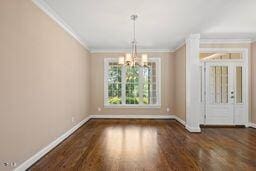 311 Rassie Crabtree Rd, Rougemont, NC 27572 - unfurnished dining area with crown molding, a chandelier, and wood finished floors