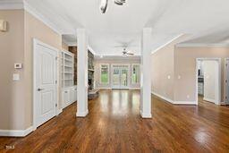 311 Rassie Crabtree Rd, Rougemont, NC 27572 - unfurnished living room with decorative columns, a ceiling fan, ornamental molding, and wood finished floors