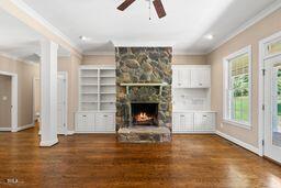 311 Rassie Crabtree Rd, Rougemont, NC 27572 - unfurnished living room with ornamental molding, ceiling fan, a stone fireplace, wood finished floors, and recessed lighting