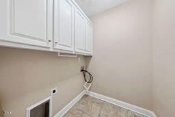 311 Rassie Crabtree Rd, Rougemont, NC 27572 - laundry area featuring cabinet space, hookup for an electric dryer, and washer hookup