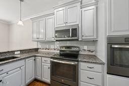 311 Rassie Crabtree Rd, Rougemont, NC 27572 - kitchen with stainless steel appliances, ornamental molding, hanging light fixtures, and dark countertops