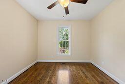 311 Rassie Crabtree Rd, Rougemont, NC 27572 - empty room featuring a ceiling fan and wood finished floors