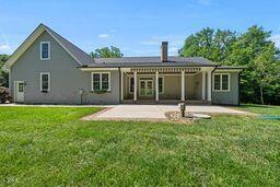 311 Rassie Crabtree Rd, Rougemont, NC 27572 - back of house with a patio, a lawn, and a chimney