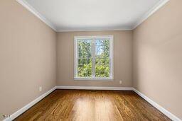 311 Rassie Crabtree Rd, Rougemont, NC 27572 - empty room with crown molding and wood finished floors