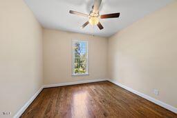 311 Rassie Crabtree Rd, Rougemont, NC 27572 - spare room with wood finished floors and a ceiling fan