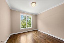 311 Rassie Crabtree Rd, Rougemont, NC 27572 - unfurnished room with crown molding and wood finished floors