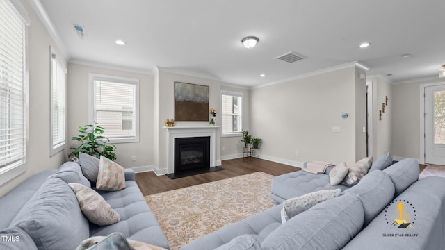 3421 Lebrun Path, Fuquay Varina, NC 27526 - living area featuring wood finished floors, ornamental molding, plenty of natural light, recessed lighting, and a fireplace with flush hearth