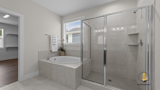 3421 Lebrun Path, Fuquay Varina, NC 27526 - bathroom with a shower stall, a garden tub, tile patterned floors, and a spacious closet