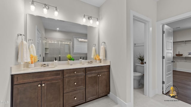 3421 Lebrun Path, Fuquay Varina, NC 27526 - bathroom with a stall shower, double vanity, tile patterned flooring, and a walk in closet