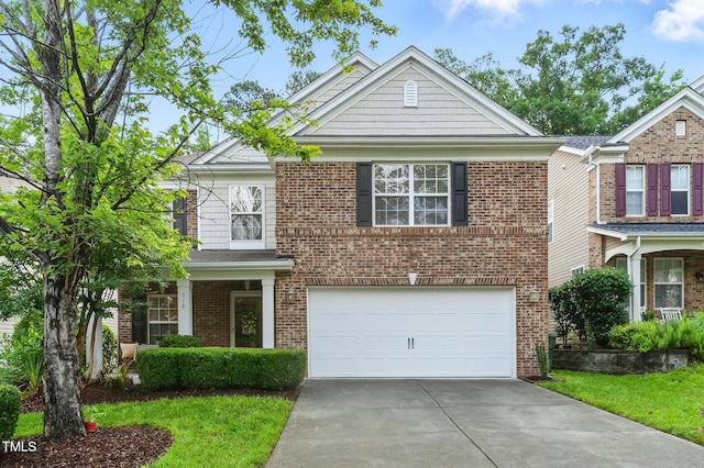 518 Emerald Downs Rd, Cary, NC 27519 - view of front of home featuring an attached garage, concrete driveway, and brick siding