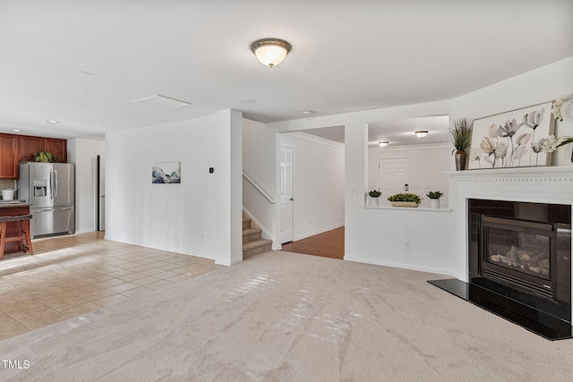 518 Emerald Downs Rd, Cary, NC 27519 - unfurnished living room featuring stairs, a glass covered fireplace, light tile patterned floors, light carpet, and recessed lighting