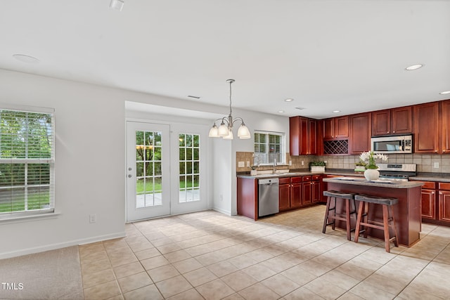 518 Emerald Downs Rd, Cary, NC 27519 - kitchen featuring appliances with stainless steel finishes, plenty of natural light, tasteful backsplash, and recessed lighting