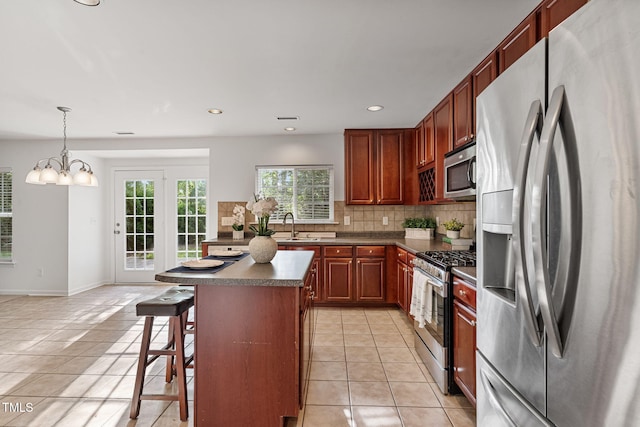 518 Emerald Downs Rd, Cary, NC 27519 - kitchen with stainless steel appliances, dark countertops, light tile patterned floors, backsplash, and recessed lighting
