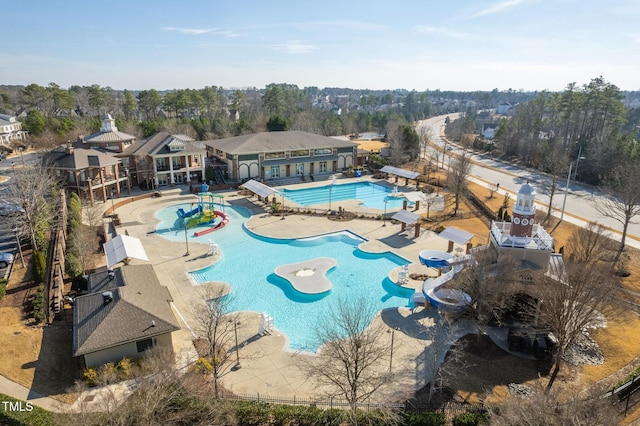 518 Emerald Downs Rd, Cary, NC 27519 - community pool featuring a water slide, a patio, and view of wooded area