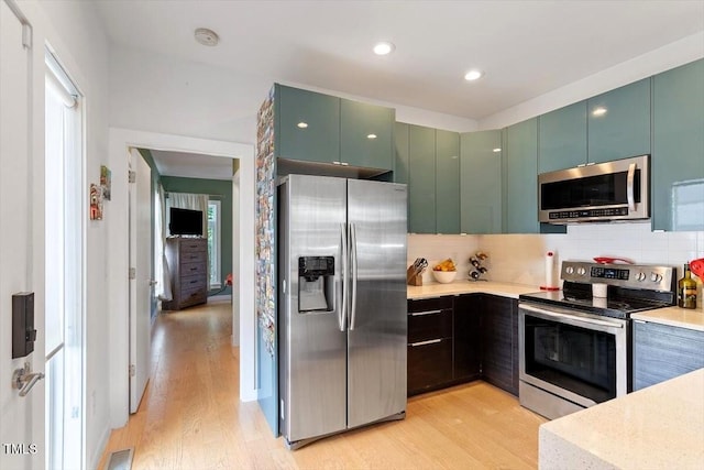 1314 S E St, Raleigh, NC 27601 - kitchen featuring appliances with stainless steel finishes, light countertops, and light wood-type flooring