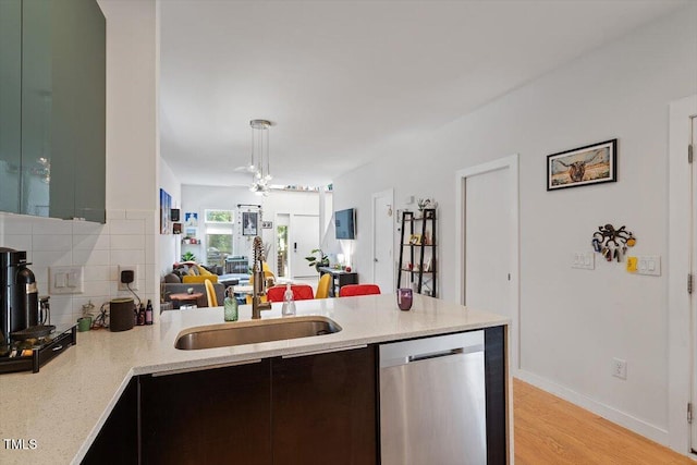 1314 S E St, Raleigh, NC 27601 - kitchen featuring dishwasher, a peninsula, open floor plan, light wood-style flooring, and tasteful backsplash