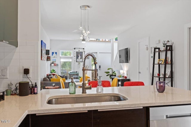 1314 S E St, Raleigh, NC 27601 - kitchen featuring open floor plan, a sink, decorative backsplash, light stone countertops, and dishwasher