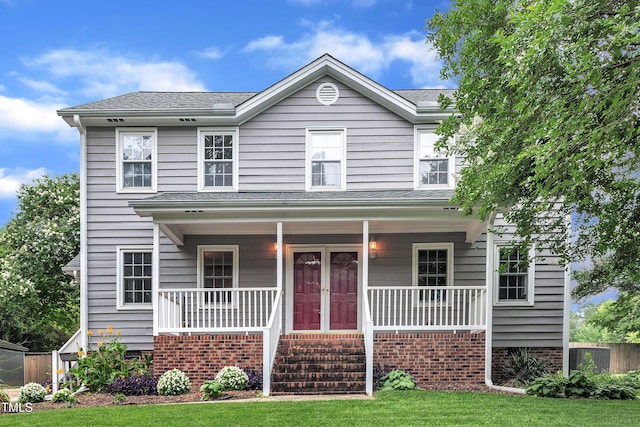 8121 Bentwood Pl, Raleigh, NC 27615 - view of front of property featuring covered porch, a front lawn, and a shingled roof