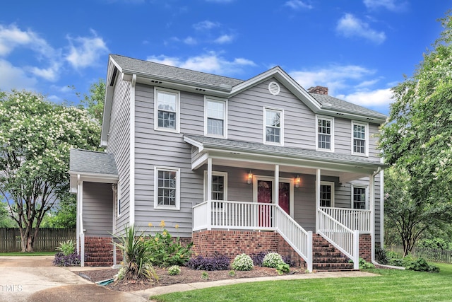 8121 Bentwood Pl, Raleigh, NC 27615 - view of front of house with stairway, a porch, a chimney, and roof with shingles
