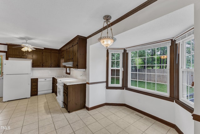 8121 Bentwood Pl, Raleigh, NC 27615 - kitchen with white appliances, light countertops, ceiling fan, and light tile patterned floors